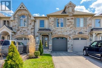 Oakville (Wm Westmount) townhouse for rent - A large, luxurious house with a stone facade and multiple garages.