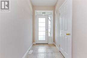 Oakville (Wm Westmount) townhouse for rent - A hallway with a white door and a tiled floor.