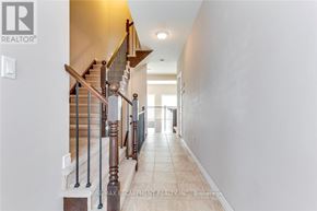Oakville (Wm Westmount) townhouse for rent - A hallway with a staircase and a light switch on the wall.
