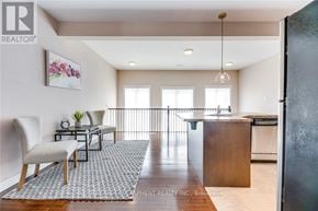 Oakville (Wm Westmount) townhouse for rent - A modern kitchen with a dining table and chairs.