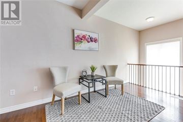 Oakville (Wm Westmount) townhouse for rent - A living room with a sofa, chair, and a table with a plant on it.