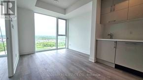 Markham (Unionville) condo for rent - A spacious room with a view of the outdoors through large windows.