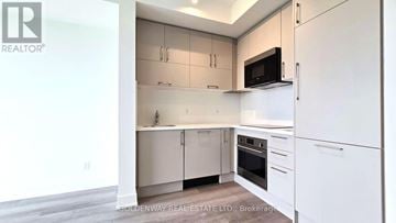 Markham (Unionville) condo for rent - A kitchen with white cabinets and appliances is on the market.