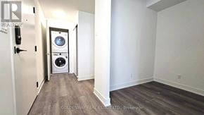 Markham (Unionville) condo for rent - A washing machine is built into a wall in a room.