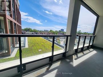 Toronto (Dovercourt-Wallace Emerson-Junction) condo for rent - A balcony with a view of a green lawn and buildings.