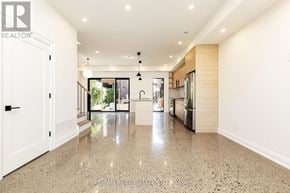 Toronto (Dovercourt-Wallace Emerson-Junction) apartment for rent - A spacious kitchen with granite countertops and a view of the backyard.