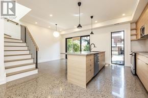 Toronto (Dovercourt-Wallace Emerson-Junction) apartment for rent - A spacious kitchen with granite countertops and a staircase on the left.