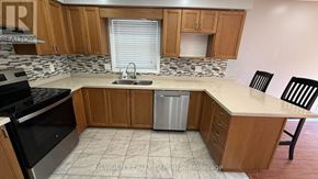 Kitchener apartment for rent - A kitchen with wooden cabinets and a granite countertop.