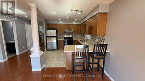 Kitchener apartment for rent - A kitchen with a dining table and chairs.