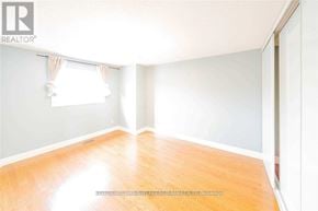 Ajax (Central) apartment for rent - A room with wooden flooring and a window with curtains.