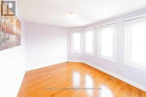 Ajax (Central) apartment for rent - A room with wooden floors and white walls with three windows.