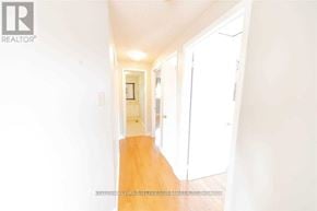 Ajax (Central) apartment for rent - A hallway with a wooden floor and white walls.