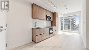 Toronto (Mount Pleasant West) condo for rent - A modern kitchen with wooden cabinets and appliances.