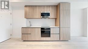 Toronto (Mount Pleasant West) condo for rent - A modern kitchen with wooden cabinets and appliances.
