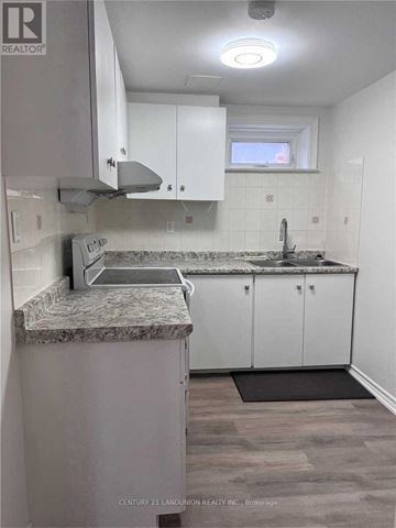 Toronto (Milliken) apartment for rent - A kitchen with granite countertops and white cabinets.