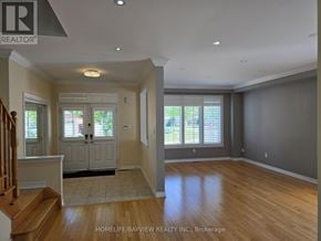 Richmond Hill (Jefferson) apartment for rent - A spacious room with wooden floors and a staircase on the left side.