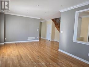 Richmond Hill (Jefferson) apartment for rent - A spacious room with wooden flooring and a staircase in the background.