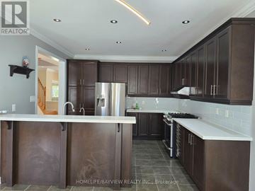 Richmond Hill (Jefferson) apartment for rent - A kitchen with dark brown cabinets and a white counter.
