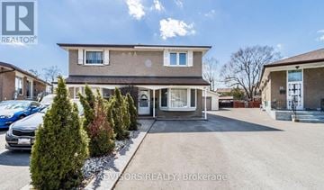 Brampton (Brampton South) apartment for rent - A house with a car parked in front of it.