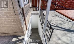 Brampton (Brampton South) apartment for rent - A stairway with a metal railing leads down to a concrete floor.