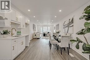 Waterloo apartment for rent - A modern kitchen with white cabinets and a dining table set for two.