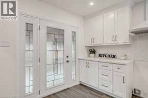 Waterloo apartment for rent - A kitchen with white cabinets and a glass door.
