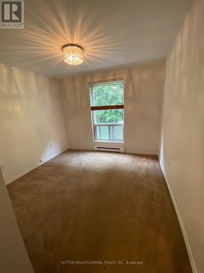 Toronto (South Riverdale) multi-family for rent - A room with a window and a light fixture on the ceiling.