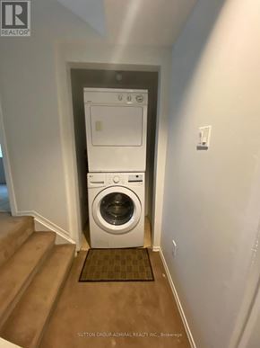 Toronto (South Riverdale) multi-family for rent - A white washer and dryer in a small room.