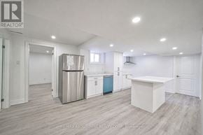 Burlington (Shoreacres) apartment for rent - A kitchen area with a white countertop and a stainless steel refrigerator.