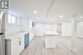 Burlington (Shoreacres) apartment for rent - A white kitchen with a refrigerator, cabinets, and a countertop.