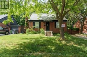 Toronto (O'connor-Parkview) apartment for rent - A house with a green lawn and a tree in front.
