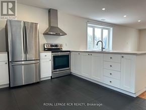 Caledon apartment for rent - A kitchen with white cabinets and a stainless steel refrigerator.
