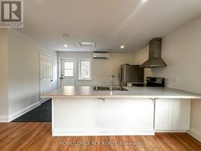 Caledon apartment for rent - A kitchen with white cabinets and a stainless steel refrigerator.