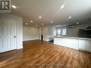 Caledon apartment for rent - A spacious room with wooden flooring and white walls.