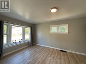 Niagara Falls (Downtown) apartment for rent - A room with a window and a wooden floor.