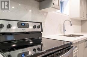 Hamilton (Gilbert) duplex for rent - A modern kitchen with a stove top oven and a sink.