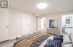 Hamilton (Gilbert) duplex for rent - A bedroom with a bed, a couch, and a painting on the wall.