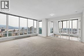Vancouver apartment for rent - A large, empty room with a view of the cityscape outside the windows.