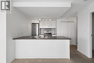 Vancouver apartment for rent - A white kitchen with a countertop and a fridge.