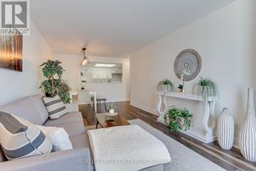 Barrie (City Centre) condo for rent - A living room with a grey couch and a white sofa.