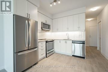 Vaughan (Concord) condo for rent - A kitchen with white cabinets and stainless steel appliances.