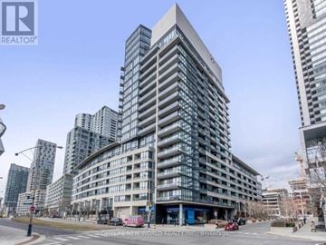 Toronto (Waterfront Communities) condo for rent - A tall building with many windows is under construction.