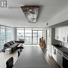 Toronto (Waterfront Communities) condo for rent - A modern living room with a large window and a view of the city.