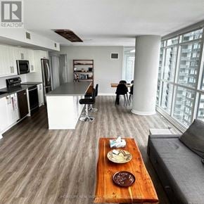 Toronto (Waterfront Communities) condo for rent - A modern kitchen with a dining area and a living room.