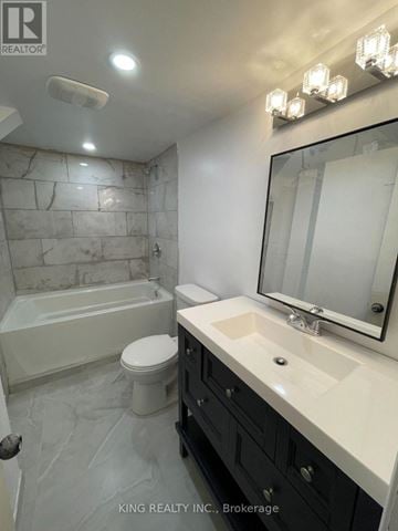 Oshawa (Donevan) apartment for rent - A bathroom with a marble wall and a white toilet.