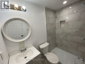 Oshawa (Donevan) apartment for rent - A bathroom with a sink, toilet, and a shower.