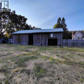 Whitchurch-Stouffville apartment for rent - A barn with a metal roof is situated in a field.