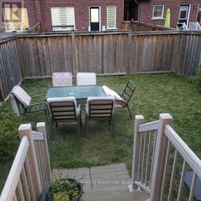 Brampton (Bram East) townhouse for rent - A backyard with a table and chairs.