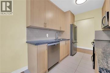 Hamilton condo for rent - A kitchen with wooden cabinets and a granite countertop.