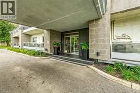 Hamilton condo for rent - A building with a Realtor sign on the front.